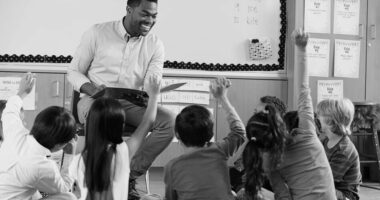A teacher smiling with pupils